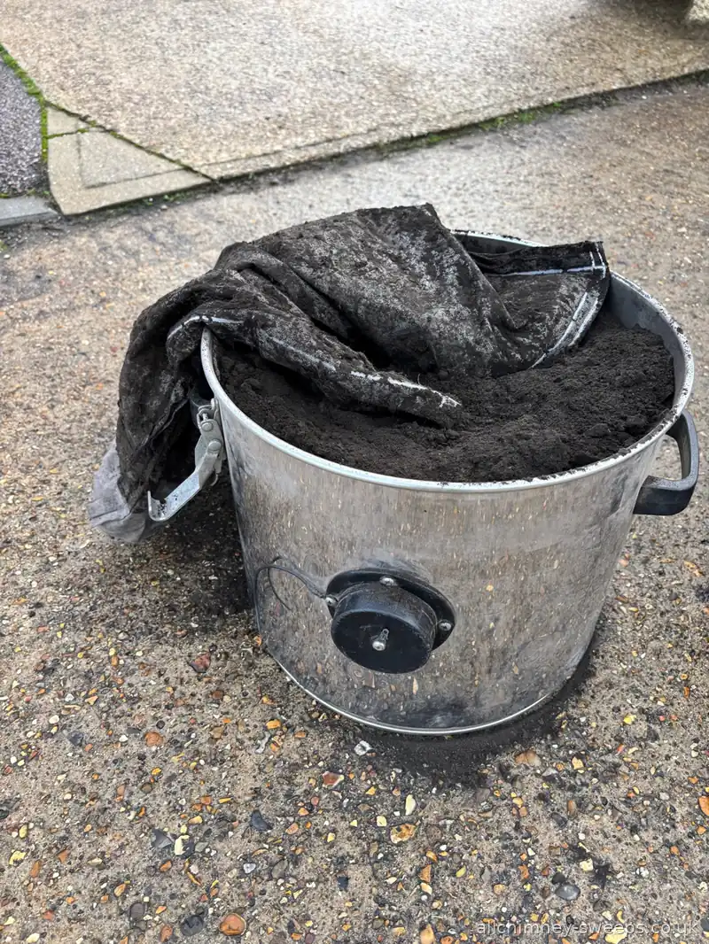 Industrial vacuum full of soot removed from badly maintained solid fuel open fireplace — professional chimney sweep service, NACS registered, Allchimney Sweeps, Hornchurch