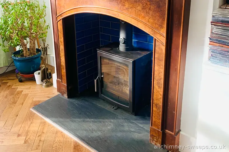 Wood burning stove chimney sweep and smoke test in 1920s period property — original tiled surround and slate hearth, NACS registered, Allchimney Sweeps, Hornchurch