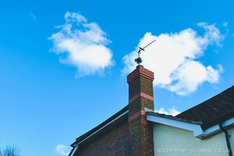 Chimney sweep brush through chimney pot on residential property — NACS registered chimney sweep, open fire coal and wood, Allchimney Sweeps, Romford
