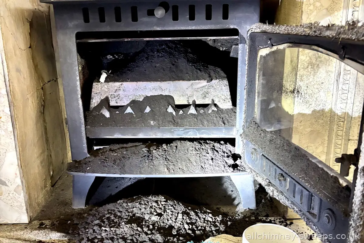 Wood burning stove not swept for four years — heavy soot buildup causing bad draw, carbon monoxide risk and chimney fire hazard. Annual chimney sweep essential, NACS registered, Allchimney Sweeps, East London