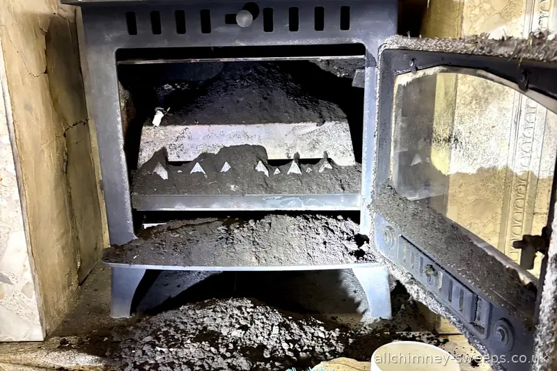 Wood burning stove not swept for four years — heavy soot buildup causing bad draw, carbon monoxide risk and chimney fire hazard. Annual chimney sweep essential, NACS registered, Allchimney Sweeps, East London