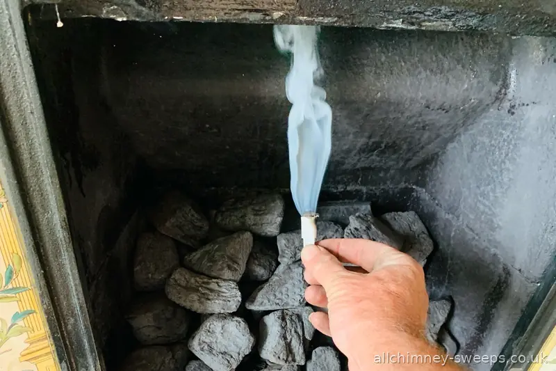 Smoke draw test on gas fuel effect appliance — Building Regulations Part J flue evacuation and spillage test, NACS registered, Allchimney Sweeps, Rise Park Romford