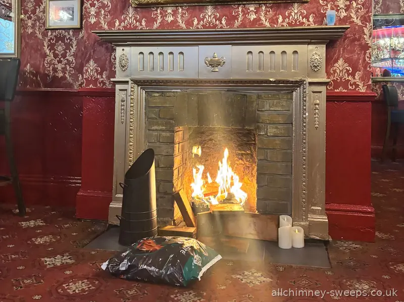 Solid fuel open fire burning in ornate fireplace — chimney swept, smoke tested and NACS certificate issued, Allchimney Sweeps, Gidea Park Romford