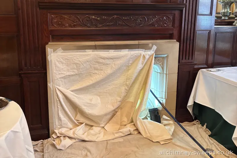 Professional chimney sweep in large period property — dust sheets protecting formal reception room, ornate carved surround, NACS registered, Allchimney Sweeps, Collier Row Romford