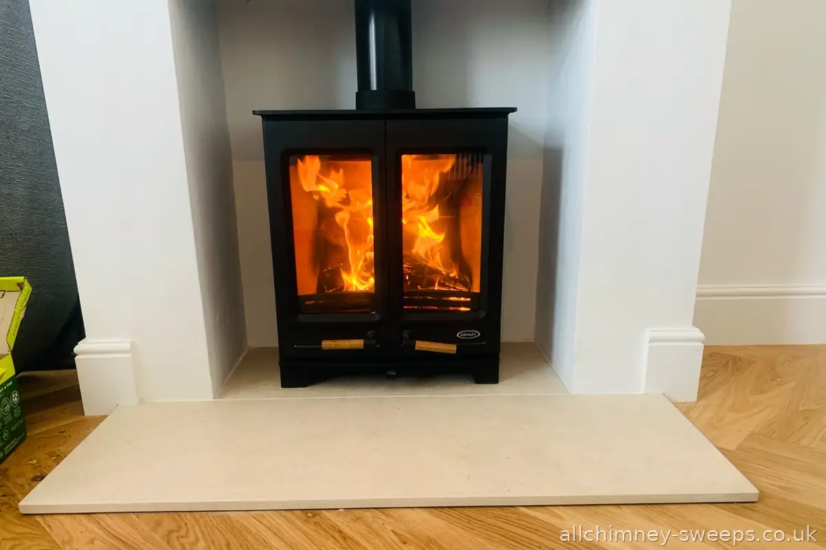 DEFRA approved Henley wood burning stove fully loaded — chimney sweep and NACS certificate, smoke controlled area, Allchimney Sweeps, Havering
