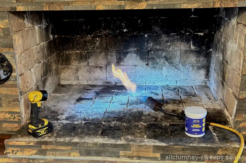 Flame torch used to heat flue prior to smoke test — specialist chimney sweep and flue inspection, experienced NACS registered sweep, Allchimney Sweeps, Romford